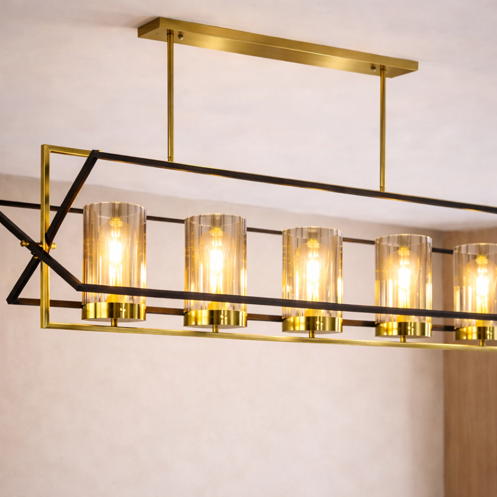 Modern ceiling light fixture with gold frame and clear glass shades on a neutral background