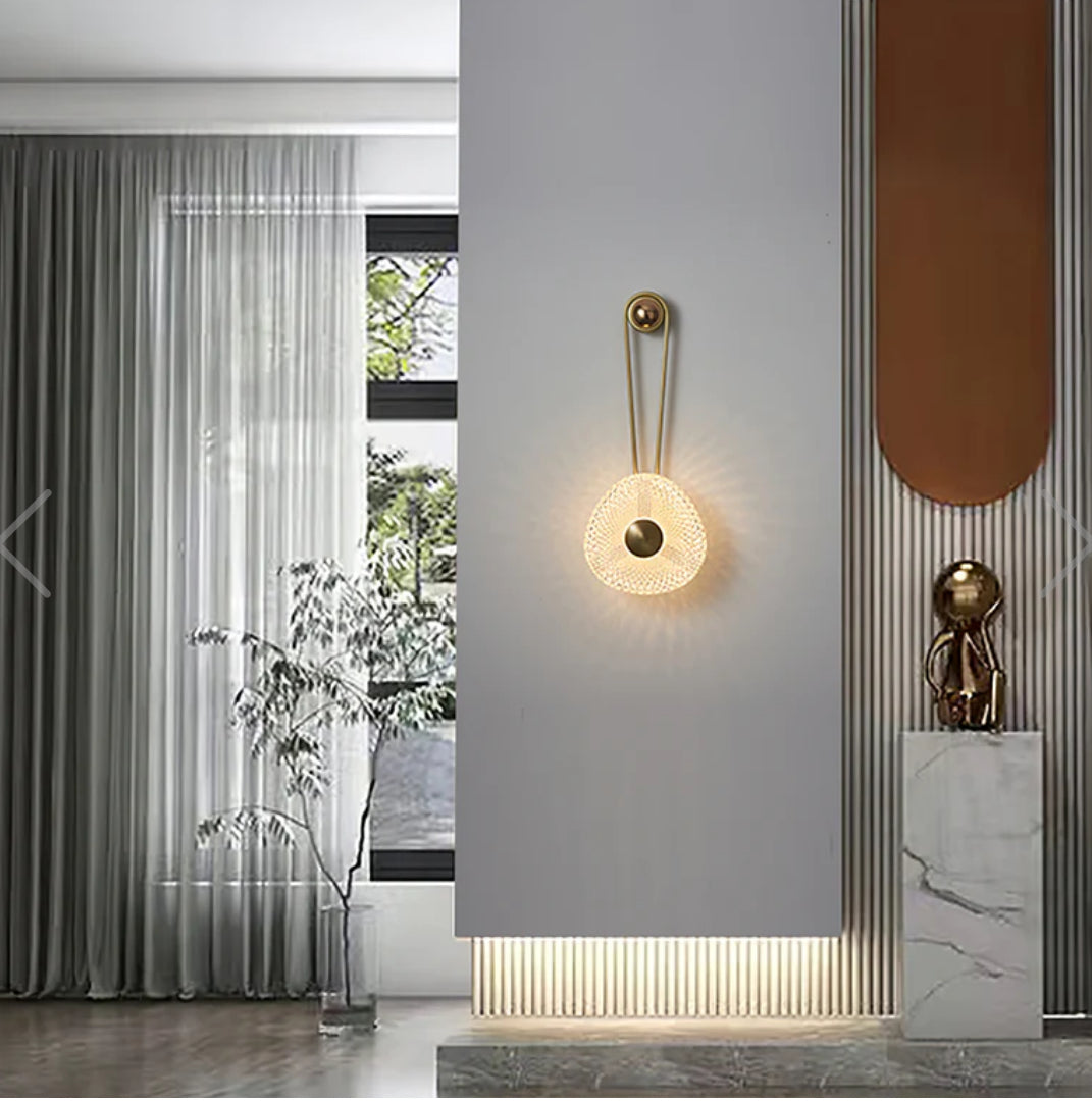 Modern wall lamp in a stylish interior setting with a window and decorative elements.