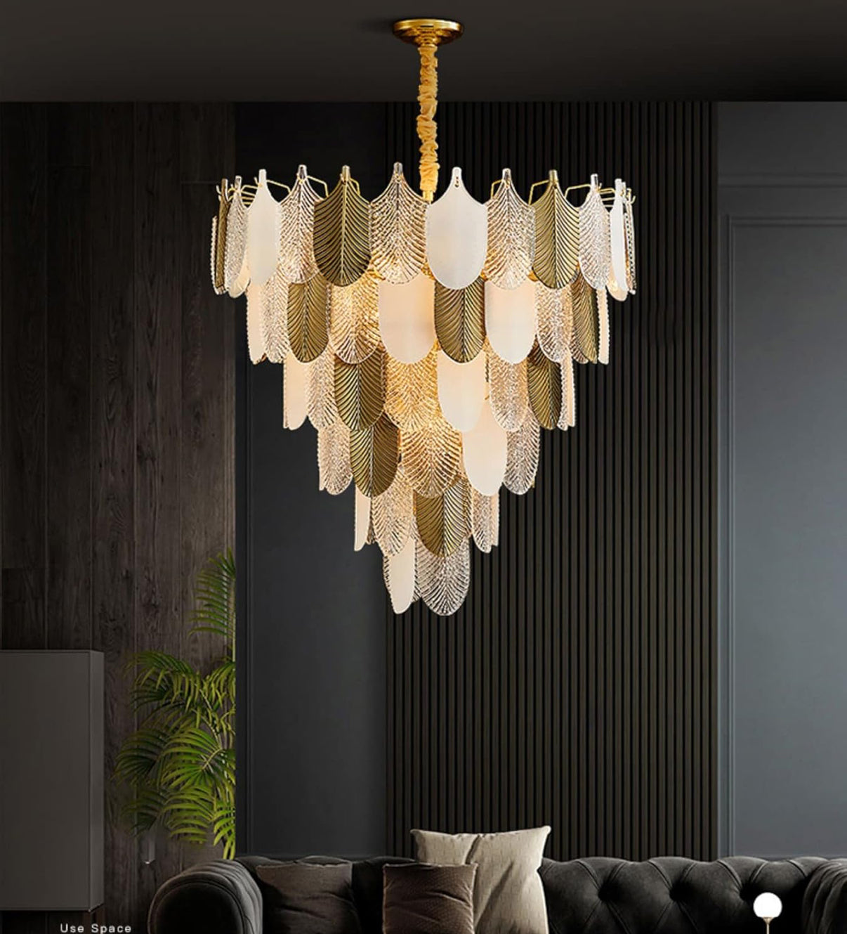 Chandelier hanging in a room with dark walls and a sofa.