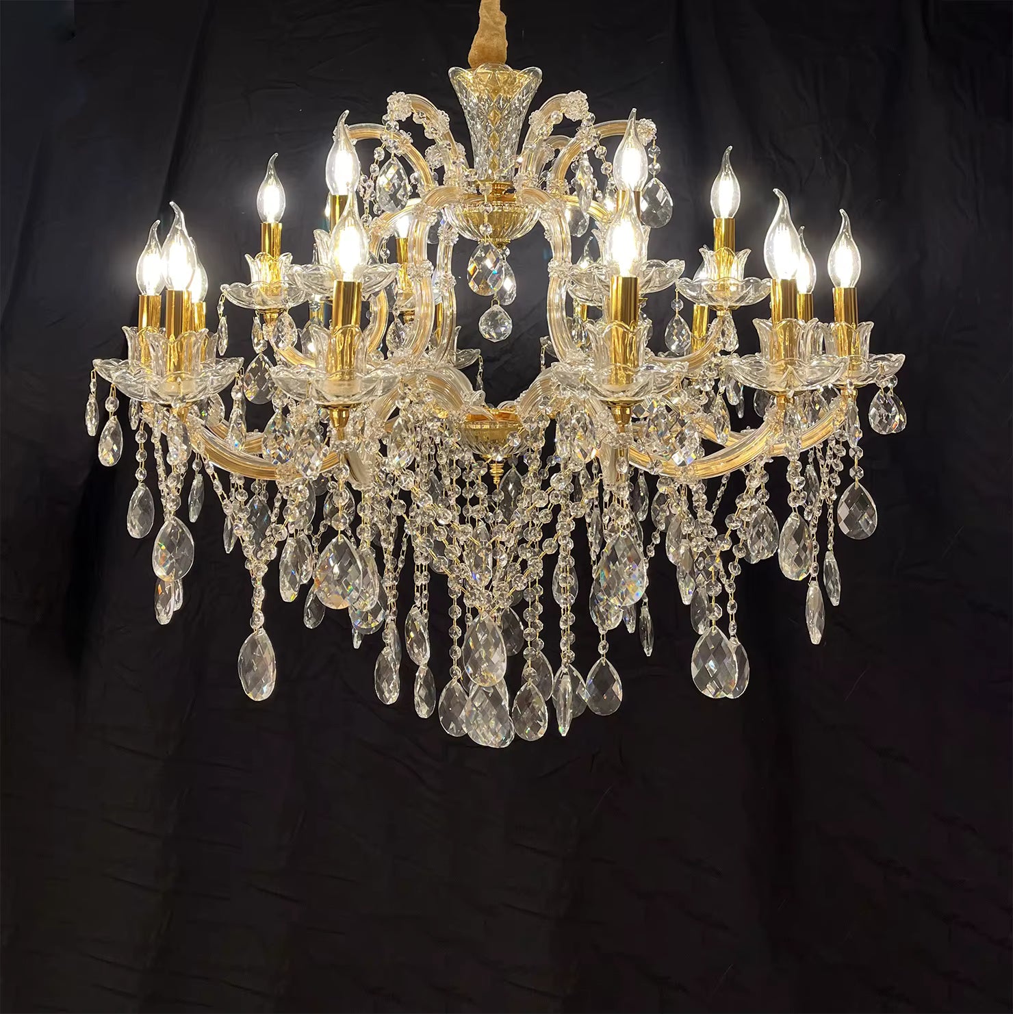 Crystal chandelier with multiple lights on a black background