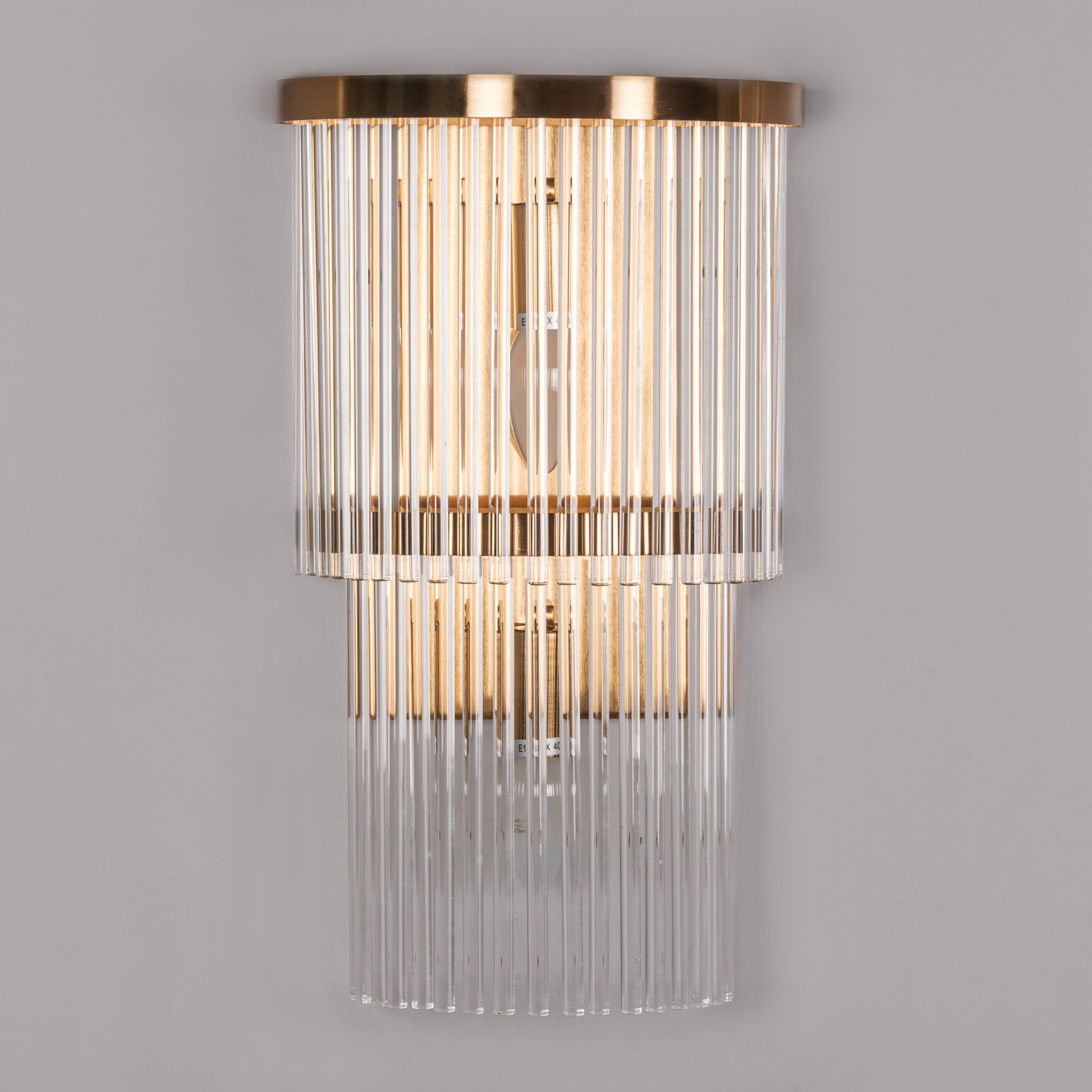 Decorative wall light fixture with glass panels on a gray background