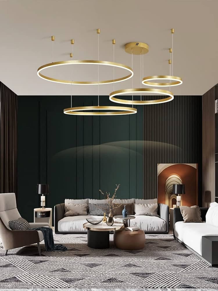 Modern living room with gold pendant lights, gray sofa, and decorative elements.