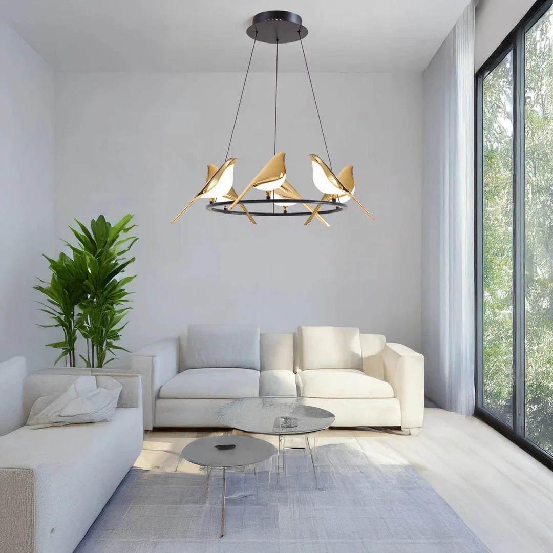 Modern living room with a stylish chandelier, white sofa, and large windows.