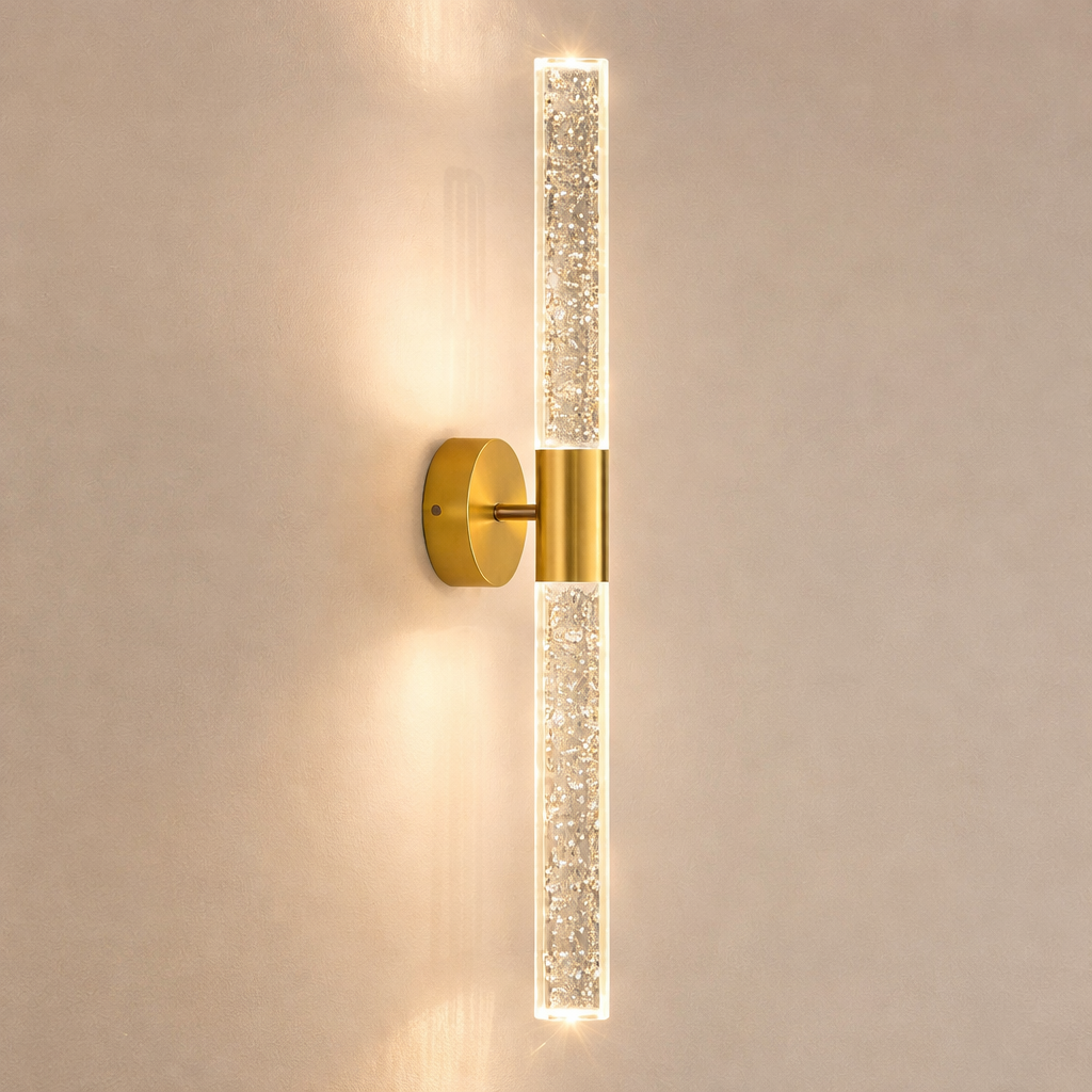 Gold wall sconce with crystal accents on a beige wall