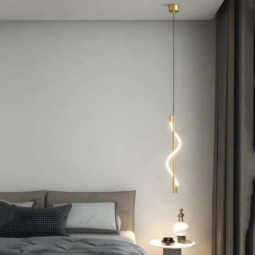 Modern bedroom with a gold pendant light and gray bedding.