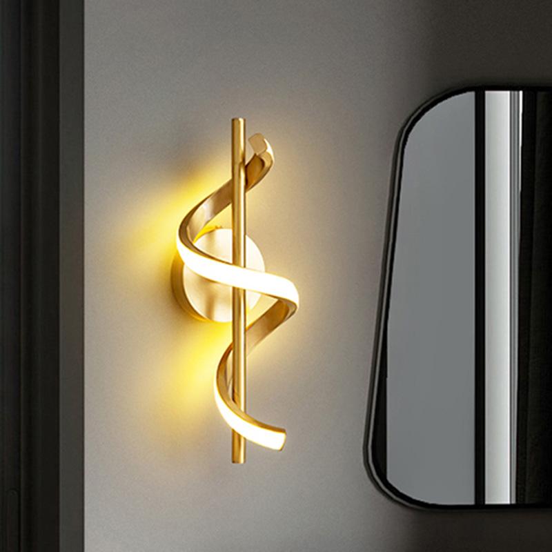 Modern wall sconce with gold spiral design on a neutral background