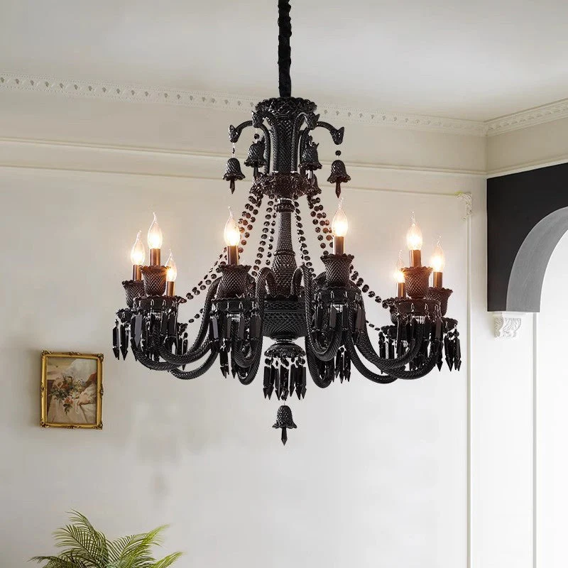 Black chandelier hanging in a room with white walls and a framed picture.