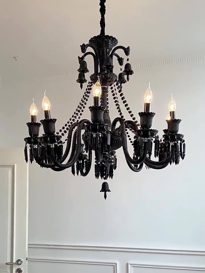 Black chandelier with six lights on a white wall