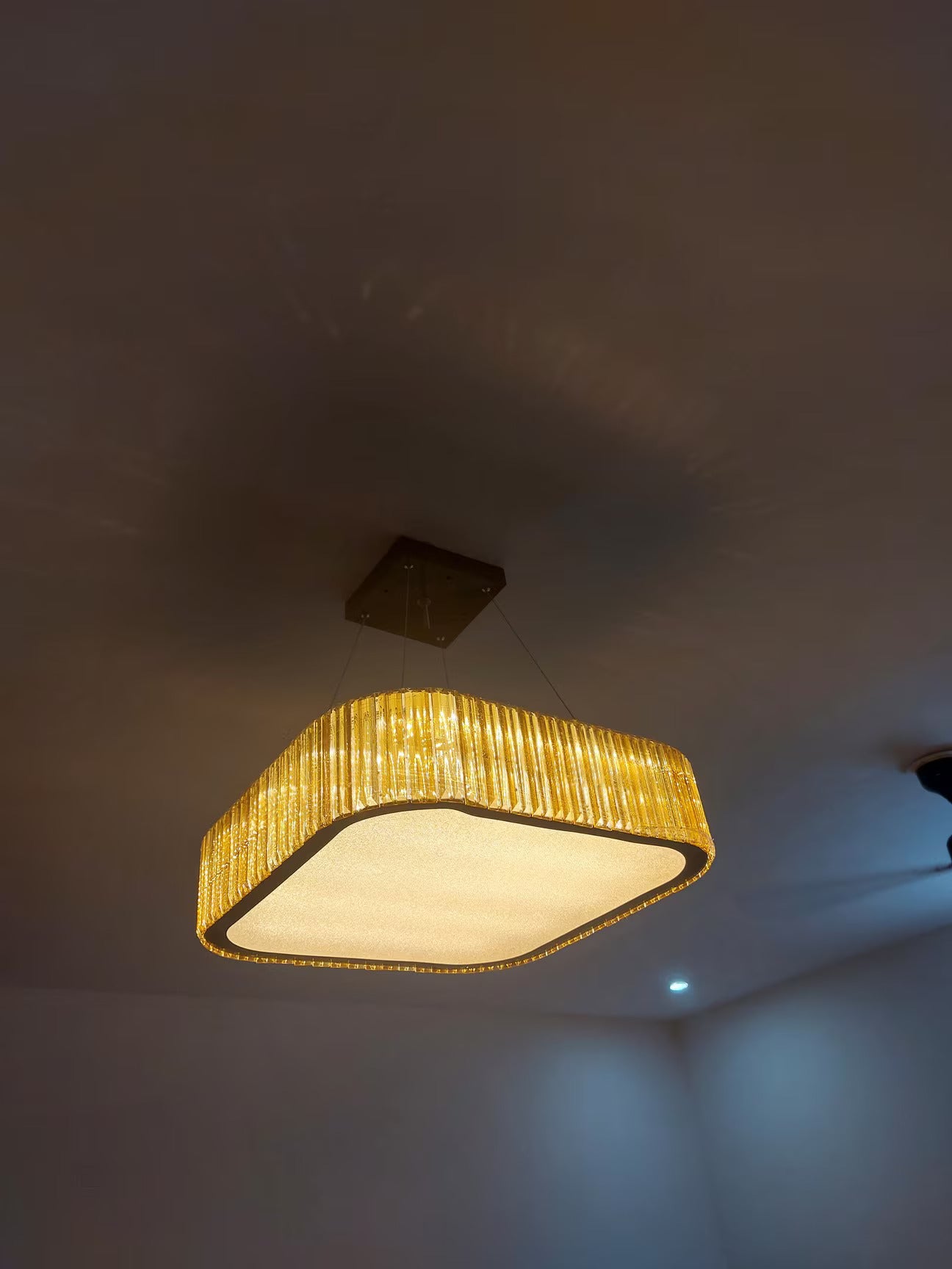 Ceiling light fixture with a textured shade on a ceiling