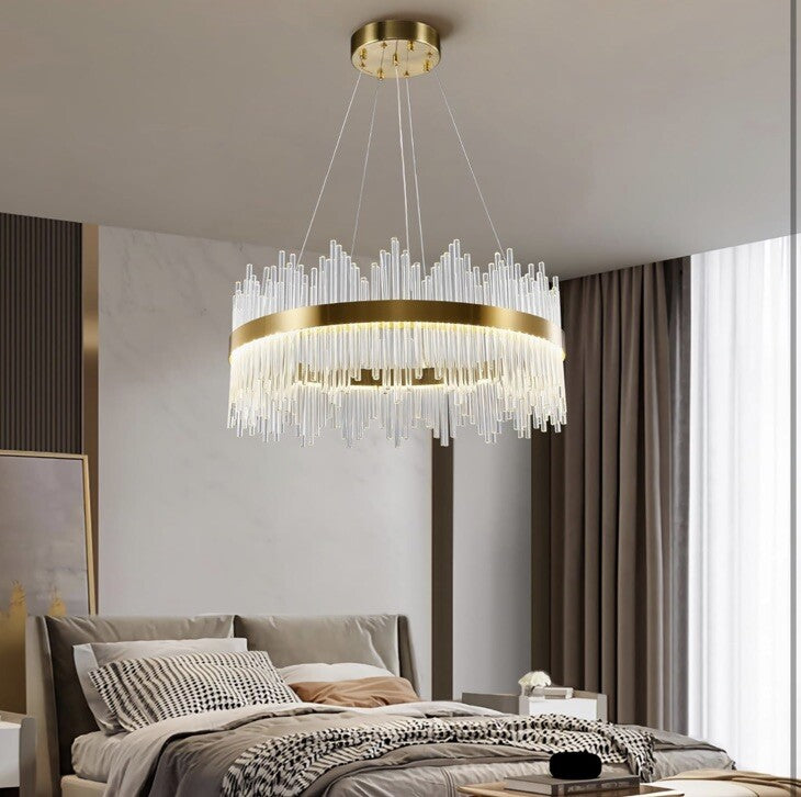 Modern chandelier hanging in a bedroom with neutral decor
