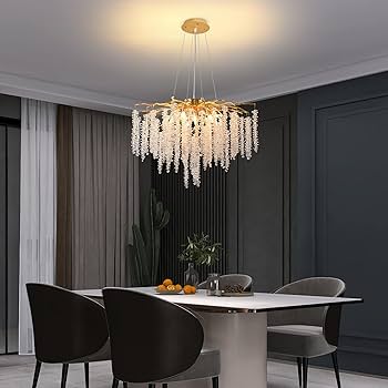 Modern dining room with a chandelier, table, and chairs.