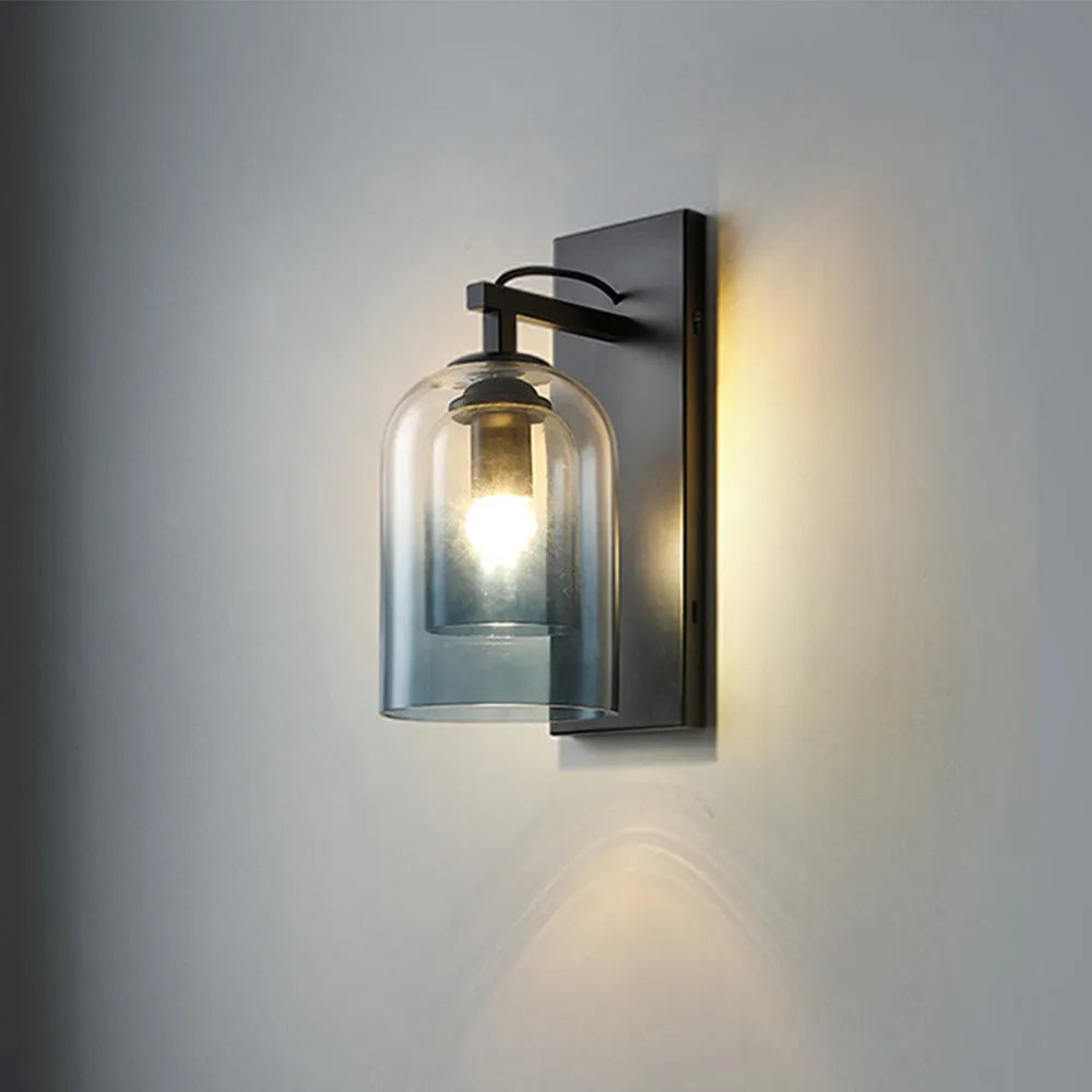 Modern wall-mounted light fixture with glass cover on a gray wall