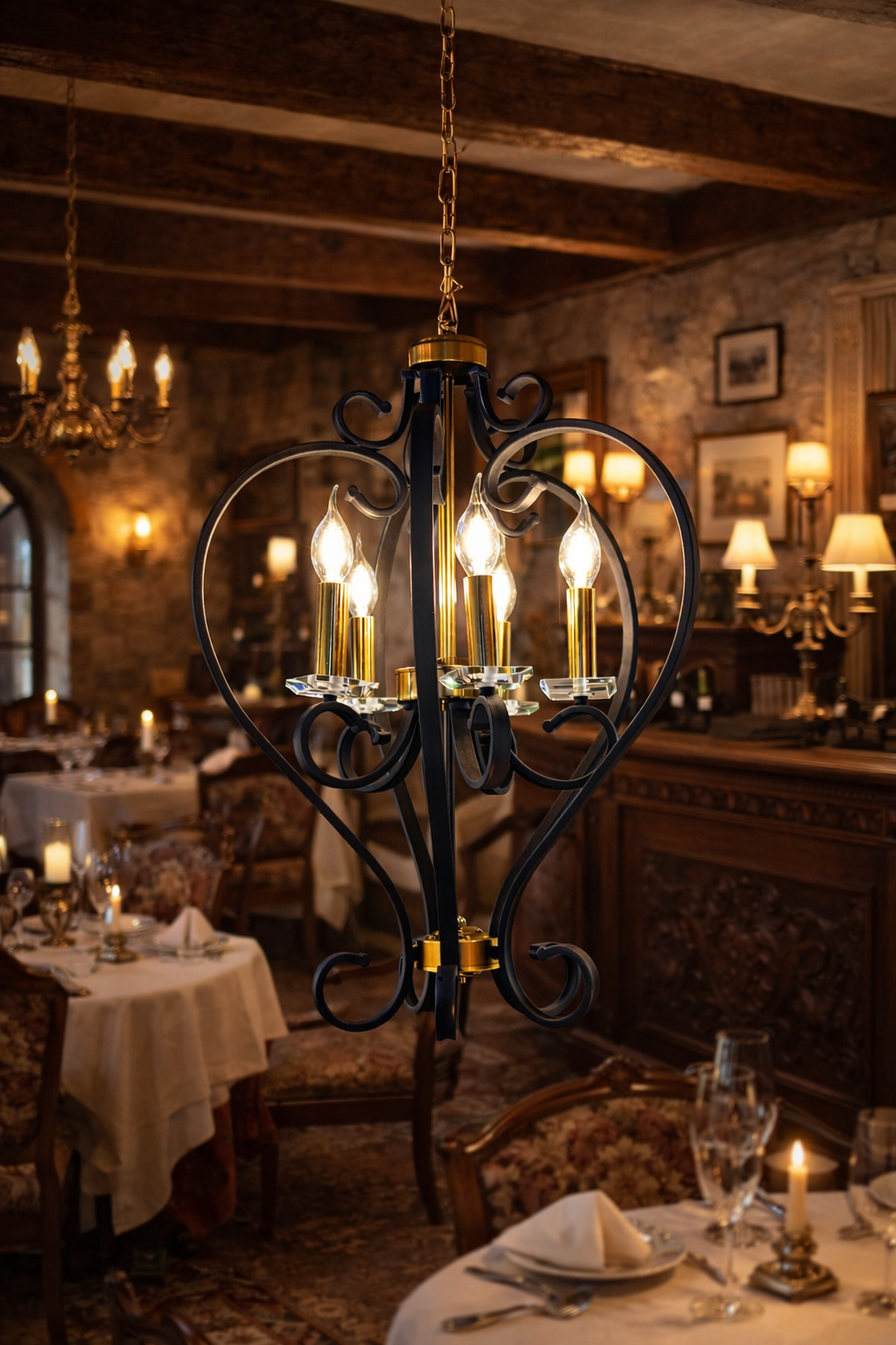 Decorative chandelier hanging in a warmly lit restaurant setting with tables and chairs.