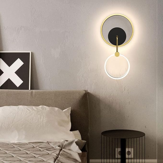 Modern wall sconce in a bedroom setting with a bed and side table.
