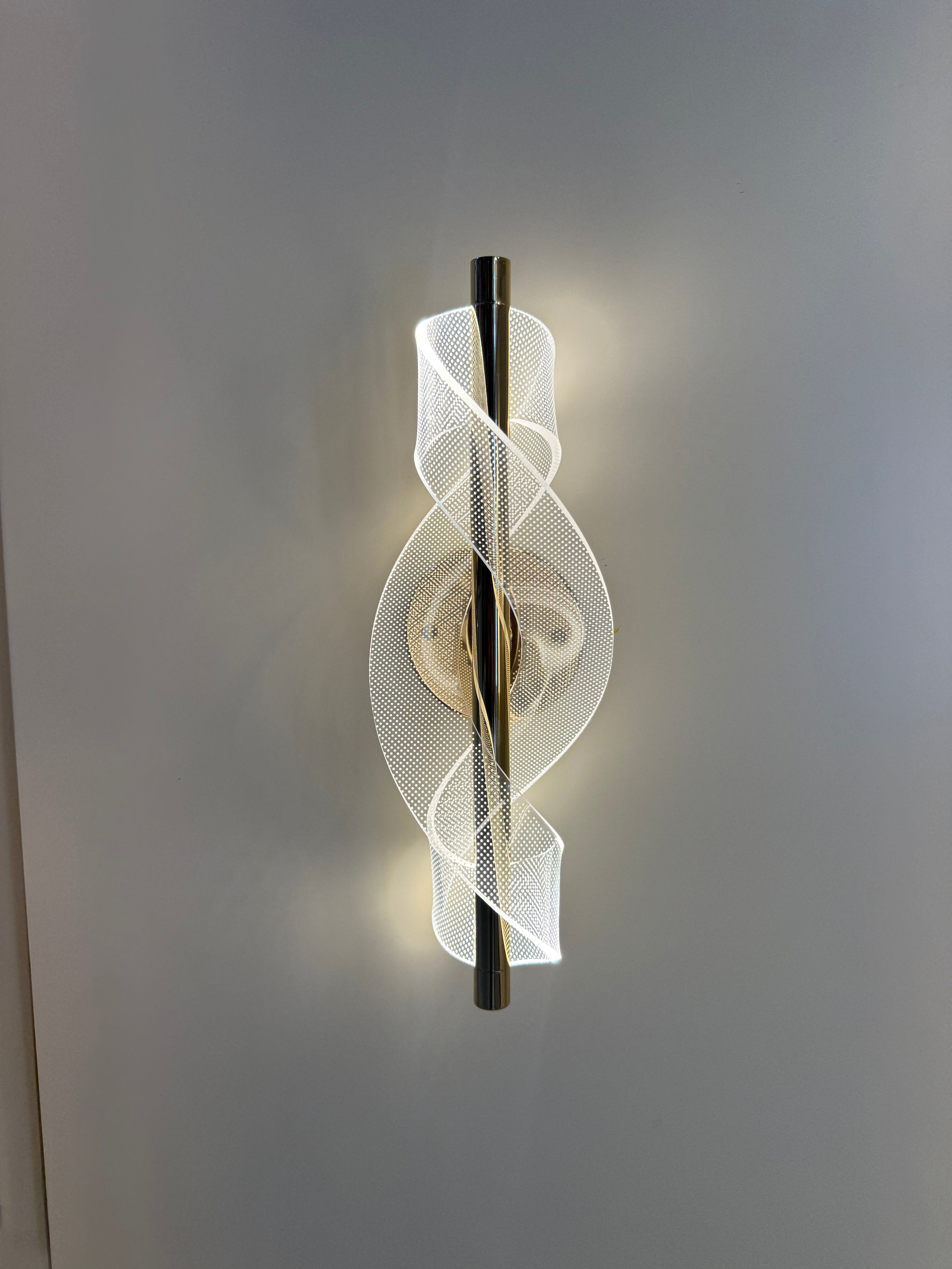 Modern wall light fixture with a geometric design on a gray background