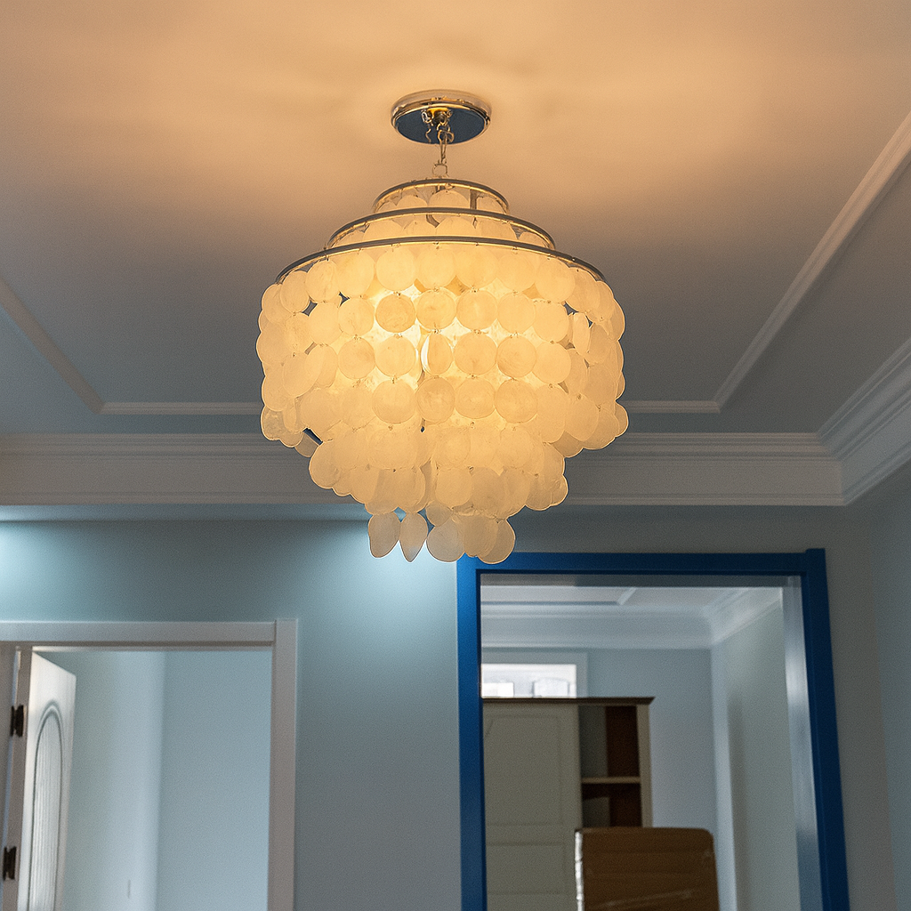 Chandelier hanging in a room with a mirror and door in the background