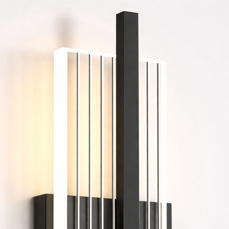 Modern wall-mounted light fixture with black and glass design on a white background