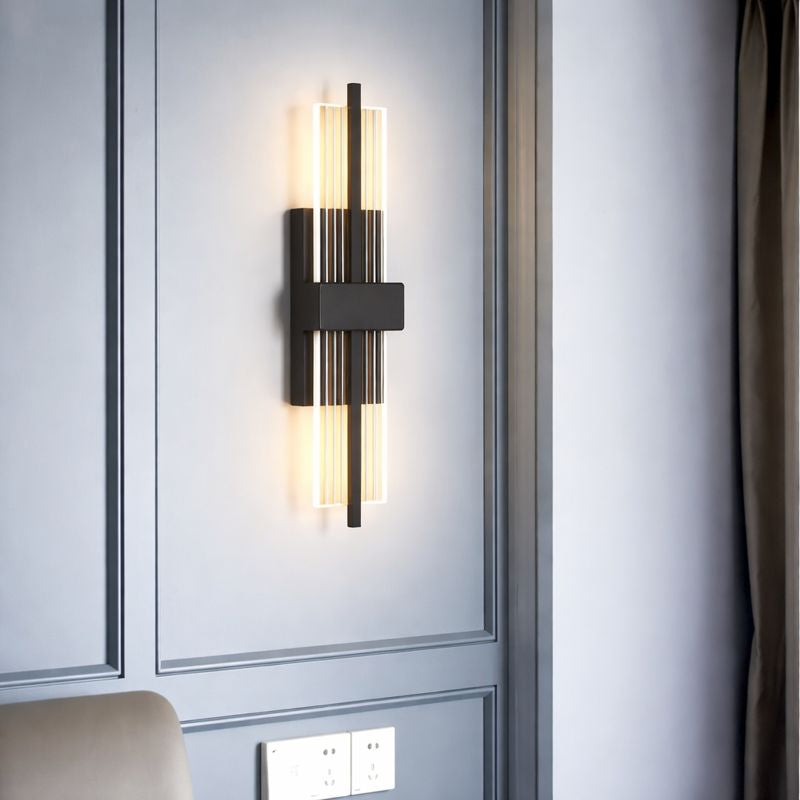 Modern wall sconce on a gray wall with a light switch below