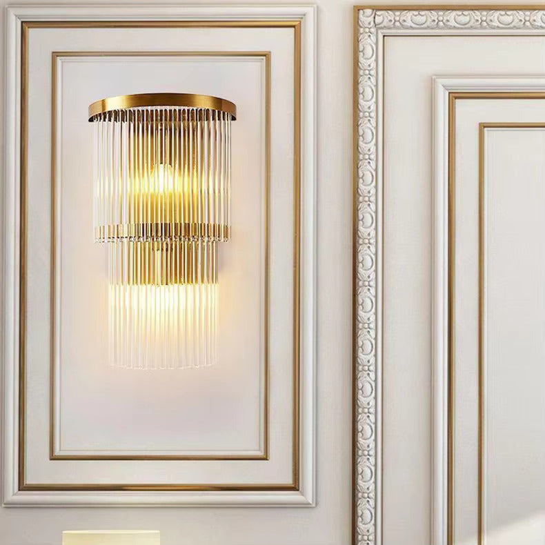 Decorative wall light fixture on a white wall with intricate molding.
