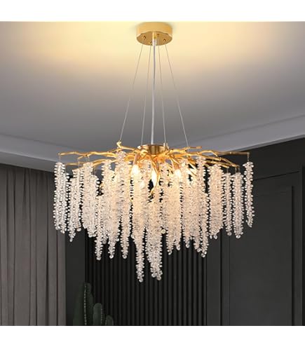Gold chandelier with crystal-like elements hanging from a ceiling.