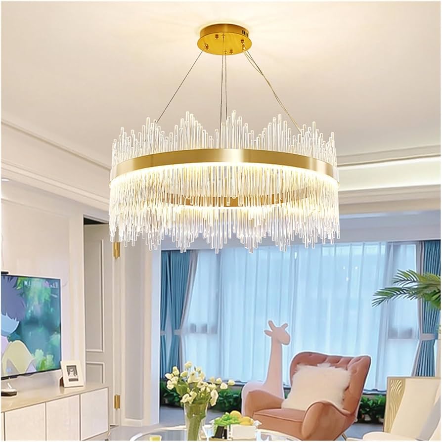 Chandelier hanging in a living room with a TV and armchair in the background